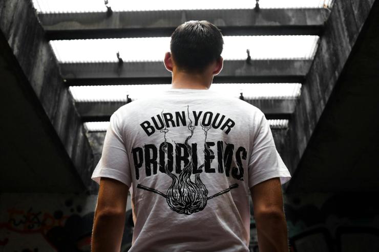 Custom shirt screen printed with the words Burn Your Problems